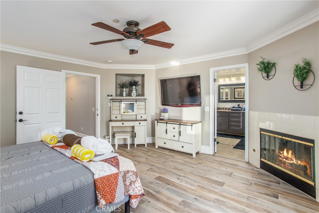 31607 Florida Street Redlands, CA 92373 - Photo 25 of 65 a bedroom with a bed a dresser and a chandelier