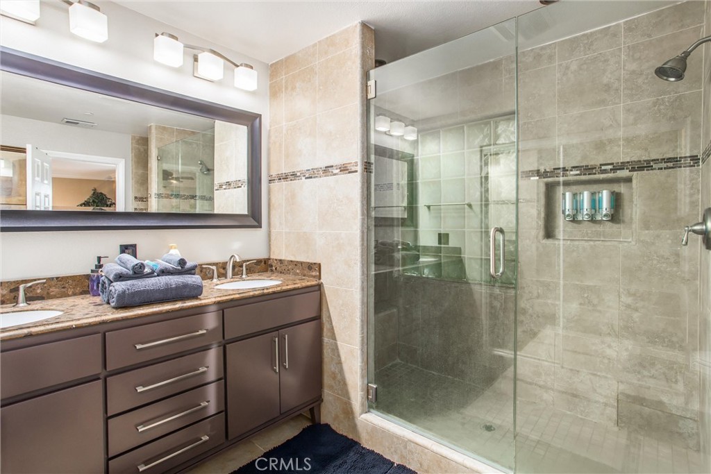 31607 Florida Street Redlands, CA 92373 - Photo 27 of 65 a bathroom with a shower sink and mirror