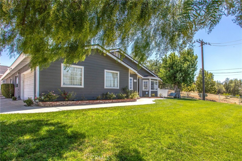 31607 Florida Street Redlands, CA 92373 - Photo 3 of 65 a front view of a house with a yard and trees