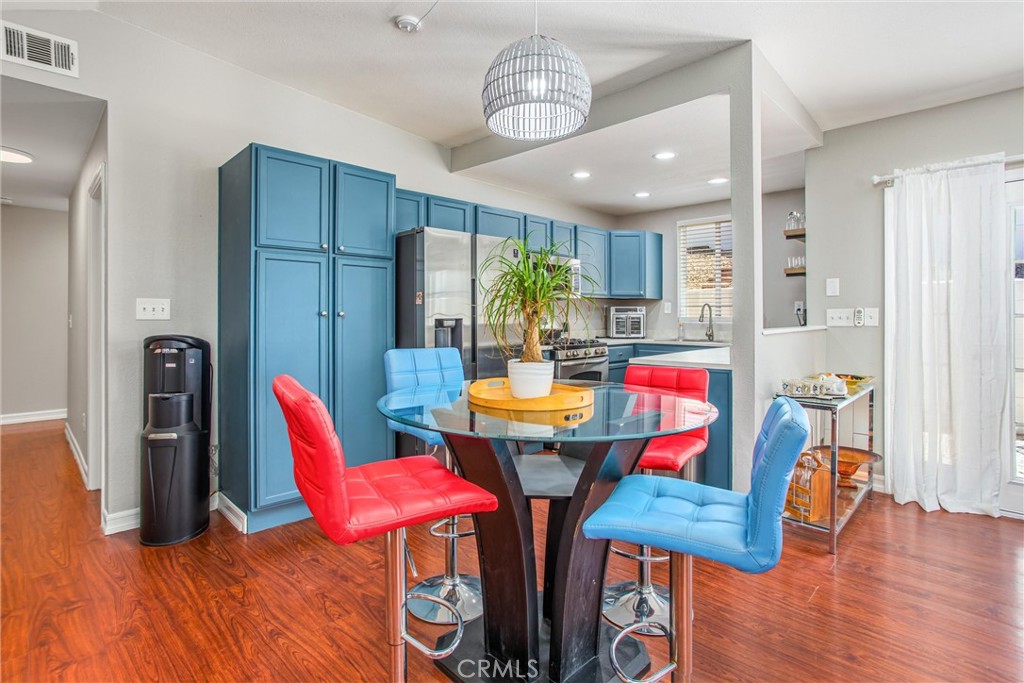 31607 Florida Street Redlands, CA 92373 - Photo 47 of 65 a view of a dining room with furniture a chandelier and wooden floor