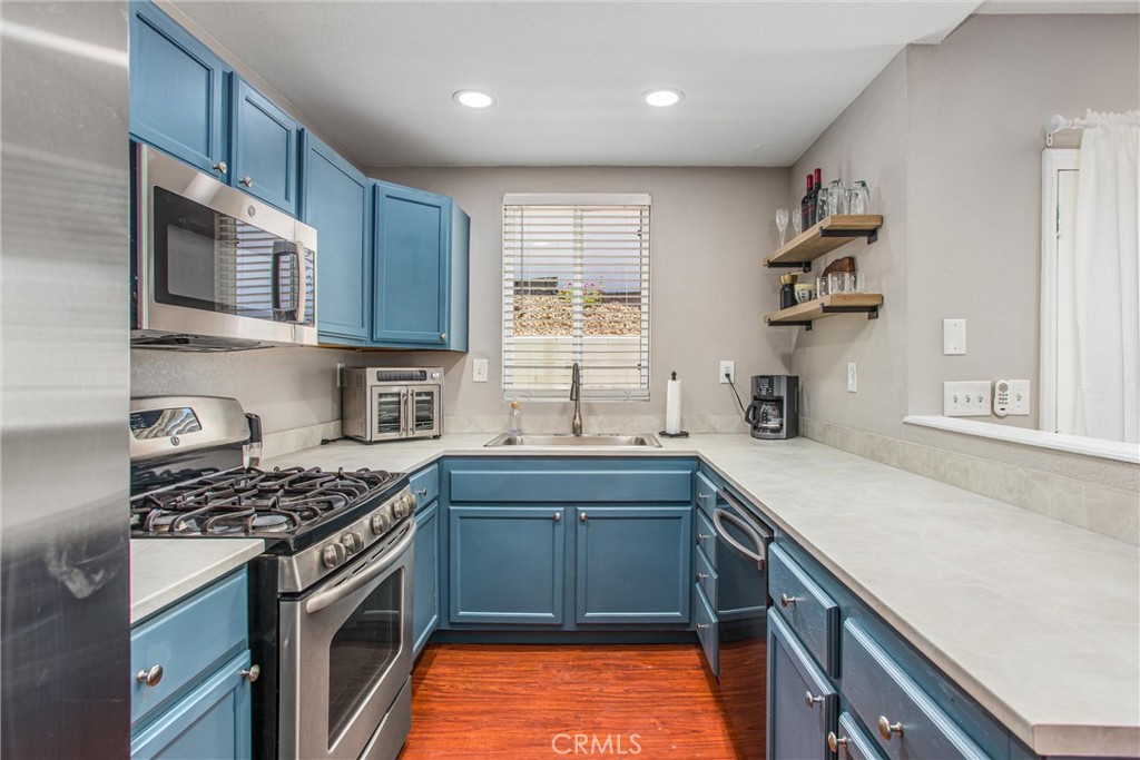 31607 Florida Street Redlands, CA 92373 - Photo 49 of 65 a kitchen with stainless steel appliances granite countertop a sink stove and refrigerator
