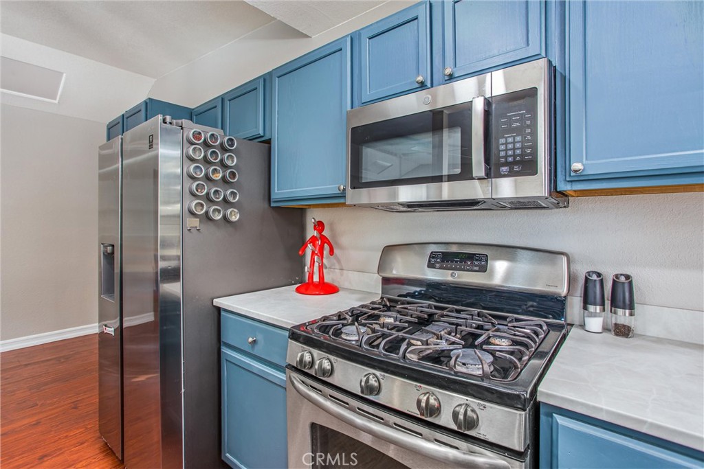 31607 Florida Street Redlands, CA 92373 - Photo 50 of 65 a kitchen with stainless steel appliances granite countertop a stove microwave and sink