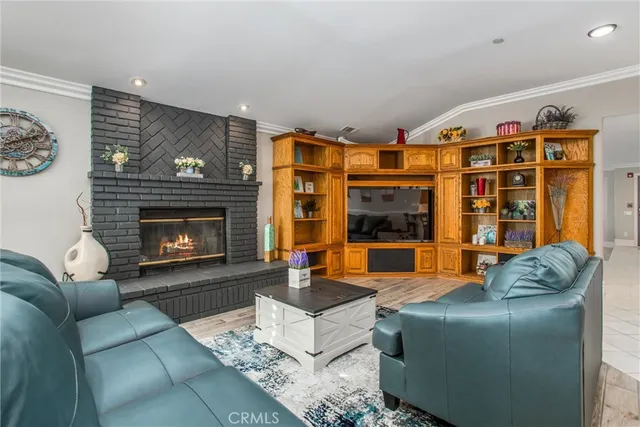 a living room with furniture kitchen view and a large window