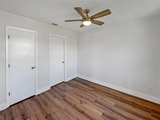 a view of a room with wooden floor