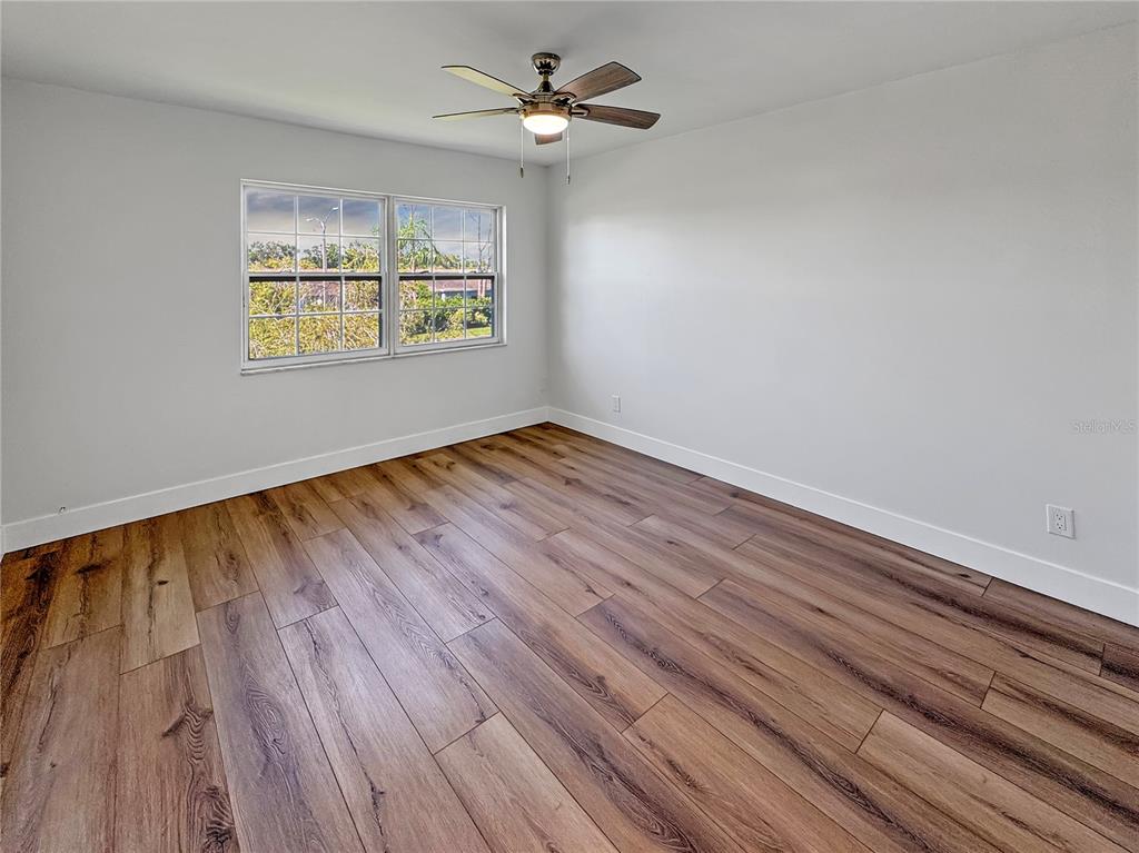 Undisclosed Address Seminole, FL 33777 - Photo 15 of 21 wooden floor in an empty room with a window