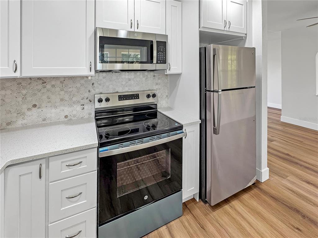 Undisclosed Address Seminole, FL 33777 - Photo 16 of 21 a kitchen with cabinets stainless steel appliances and wooden floor