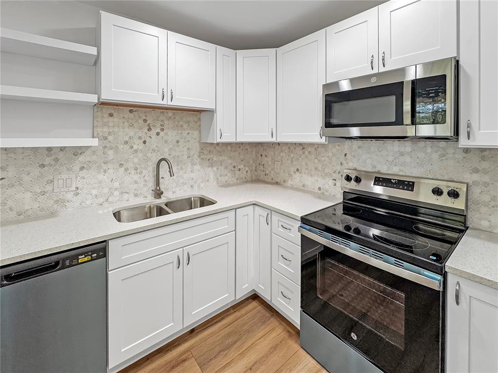 Undisclosed Address Seminole, FL 33777 - Photo 18 of 21 a kitchen with a sink stove and microwave