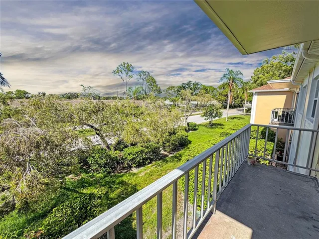 a view of a balcony with wooden floor