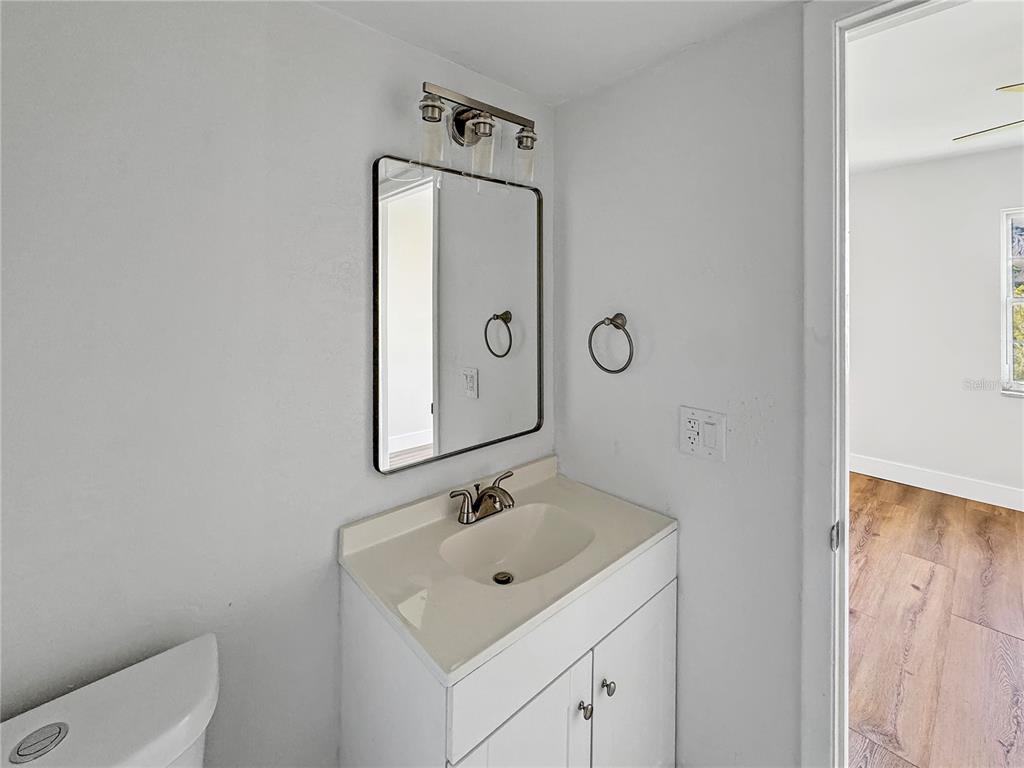 Undisclosed Address Seminole, FL 33777 - Photo 9 of 21 a bathroom with a toilet sink and mirror