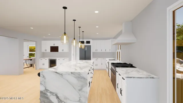 a kitchen with stainless steel appliances kitchen island granite countertop a refrigerator a stove a sink and a dining table with wooden floor