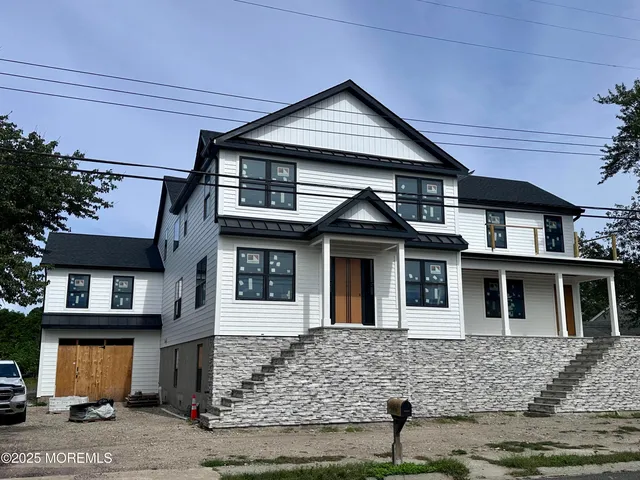 a front view of a house with large windows