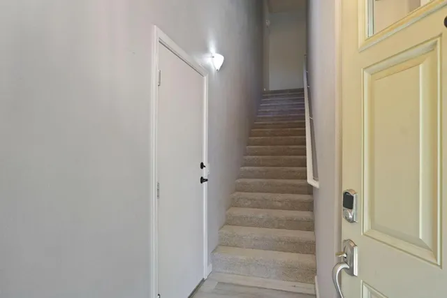 a view of a kitchen with granite countertop cabinets and chandelier