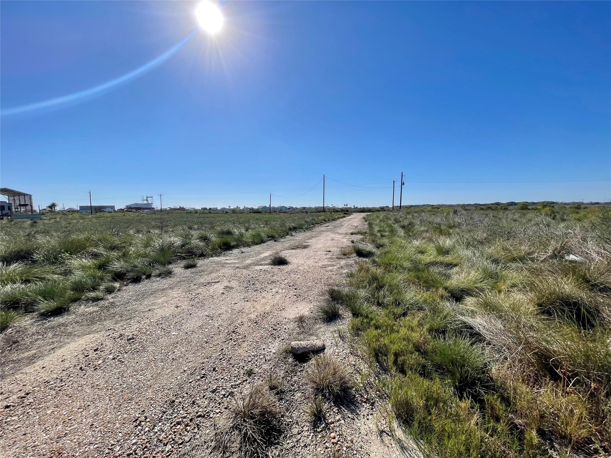 270 Titanic Street Sargent, TX 77414 - Photo 3 of 6 a view of a road with a yard
