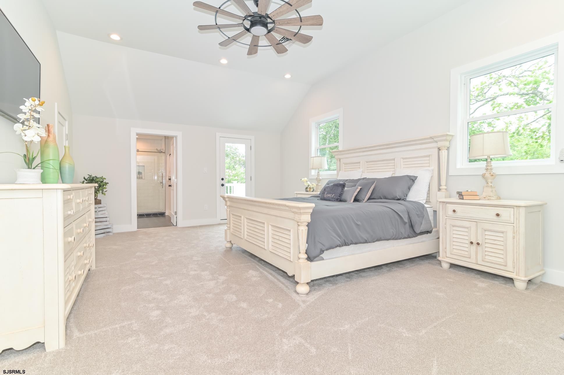 1828 Shore Road Linwood, NJ 08221 - Photo 12 of 20 a spacious bedroom with a bed and a chandelier