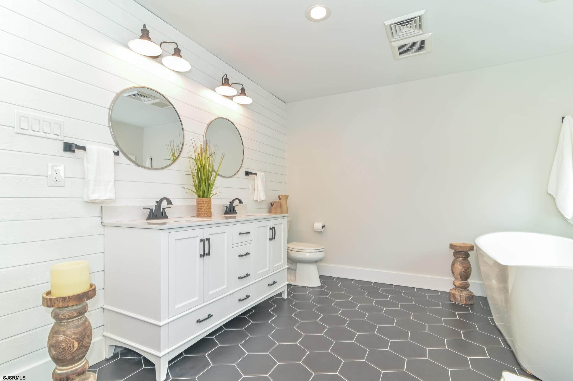 1828 Shore Road Linwood, NJ 08221 - Photo 14 of 20 a bathroom with a double vanity sink mirror and toilet