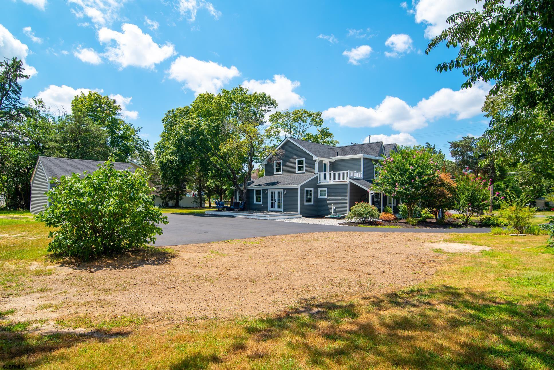 1828 Shore Road Linwood, NJ 08221 - Photo 2 of 20 a front view of a house with a yard and trees