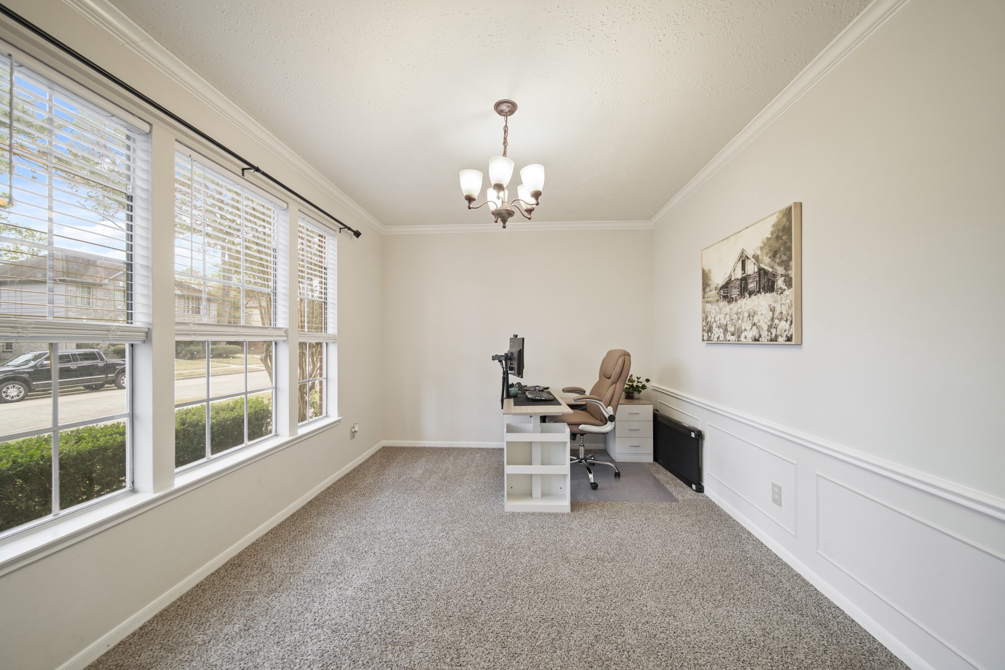 16114 Kintyre Point Road Houston, TX 77095 - Photo 10 of 44 Bright home office with large windows, neutral walls, and carpeted flooring. Features a desk, office chair, and wall art. Perfect for a productive workspace.