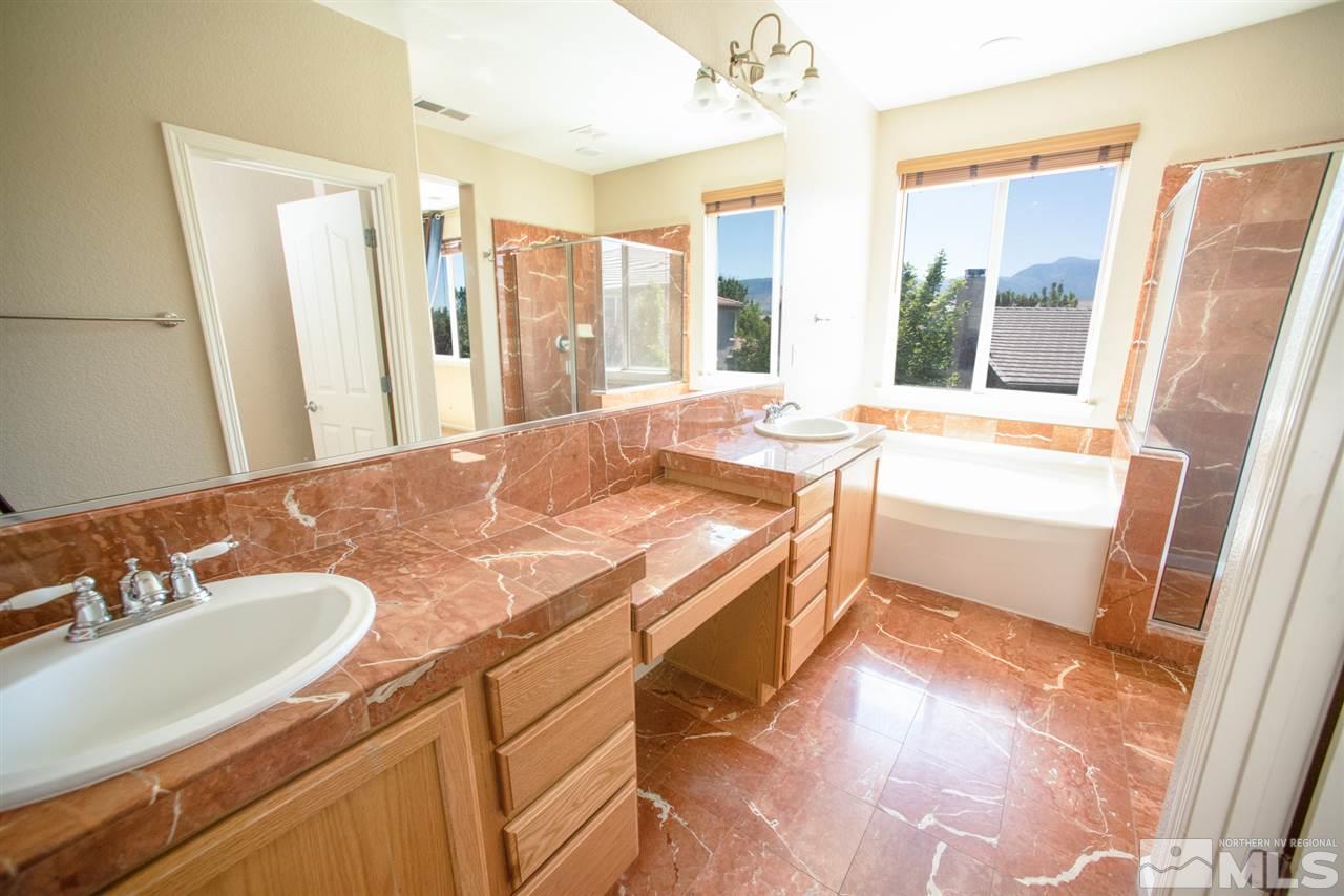 460 Silver Bridle Court Reno, NV 89521 - Photo 14 of 29 a bathroom with a granite countertop sink and a bathtub