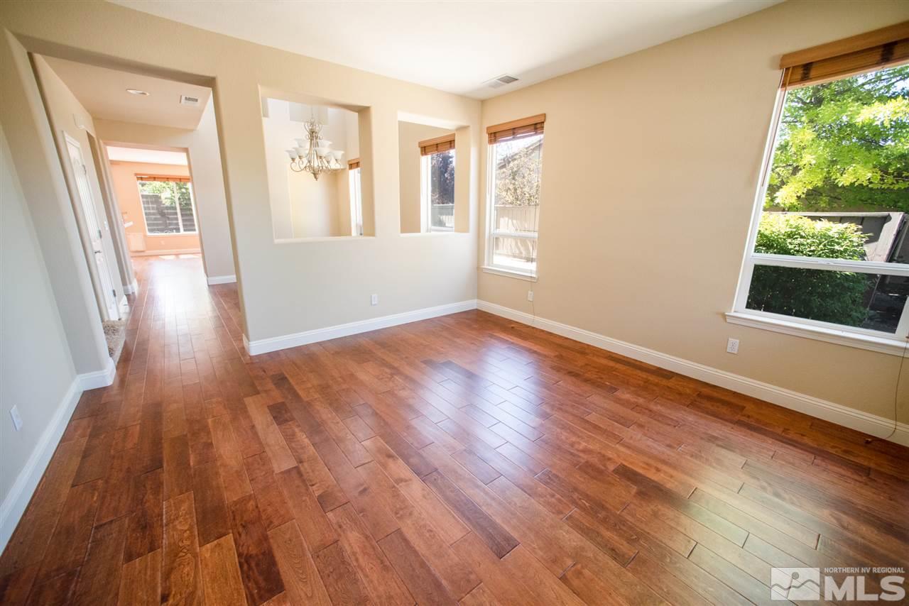 460 Silver Bridle Court Reno, NV 89521 - Photo 3 of 29 an empty room with wooden floor and windows