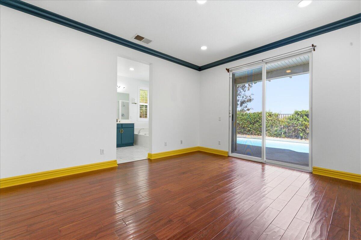 23732 Bella Vista Road Corona, CA 92883 - Photo 20 of 49 a view of empty room with wooden floor and fan