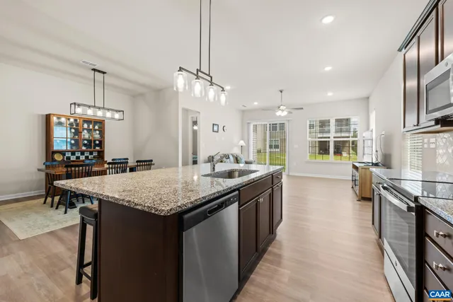 a view of a dining room with furniture and floor to ceiling window