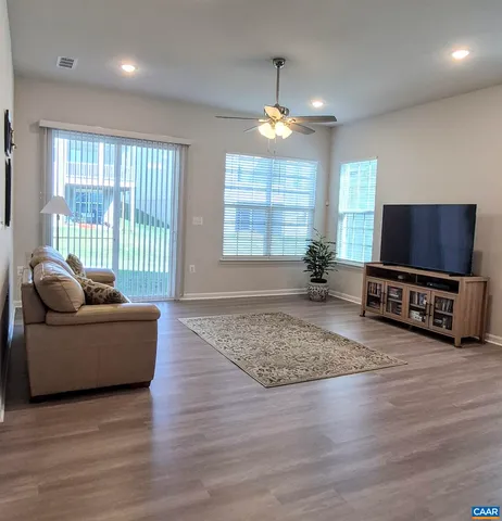a spacious bedroom with a bed and a chandelier