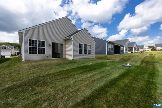 a front view of a house with a garden and plants