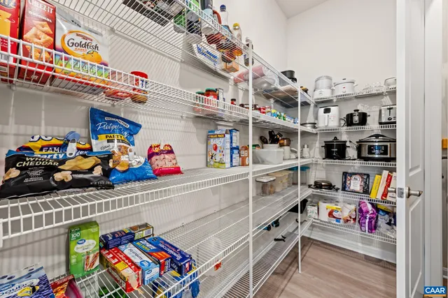 a kitchen with stainless steel appliances granite countertop a sink a stove and a wooden floors