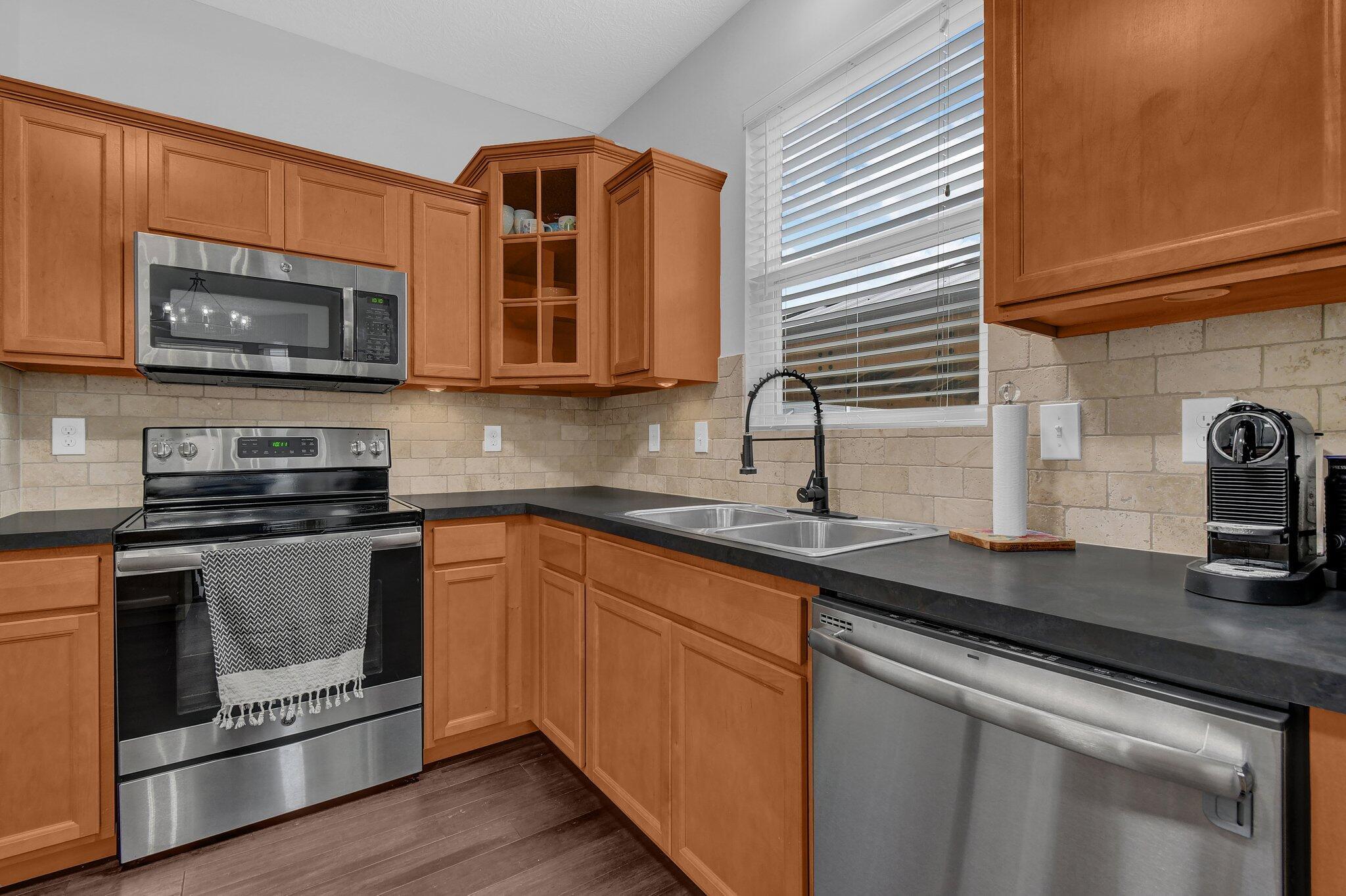 916 Rooks Circle Sunbury, OH 43074 - Photo 11 of 39 Kitchen pantry, stainless steel appliances, neutral counters, and an upgraded backsplash!