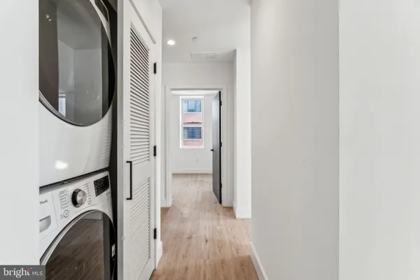 a view of a hallway with washer and dryer