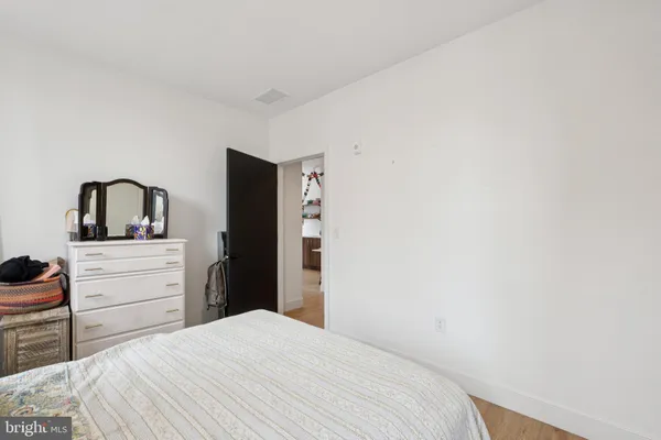 a bedroom with a bed and dresser