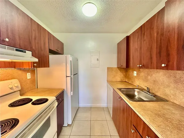 a kitchen with a stove and a refrigerator
