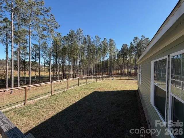 a view of a swimming pool with a yard