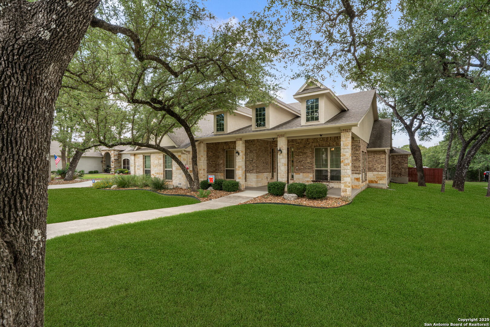 30210 Setterfeld Circle Fair Oaks Ranch, TX 78015 - Photo 2 of 30 a front view of a house with a garden and tree