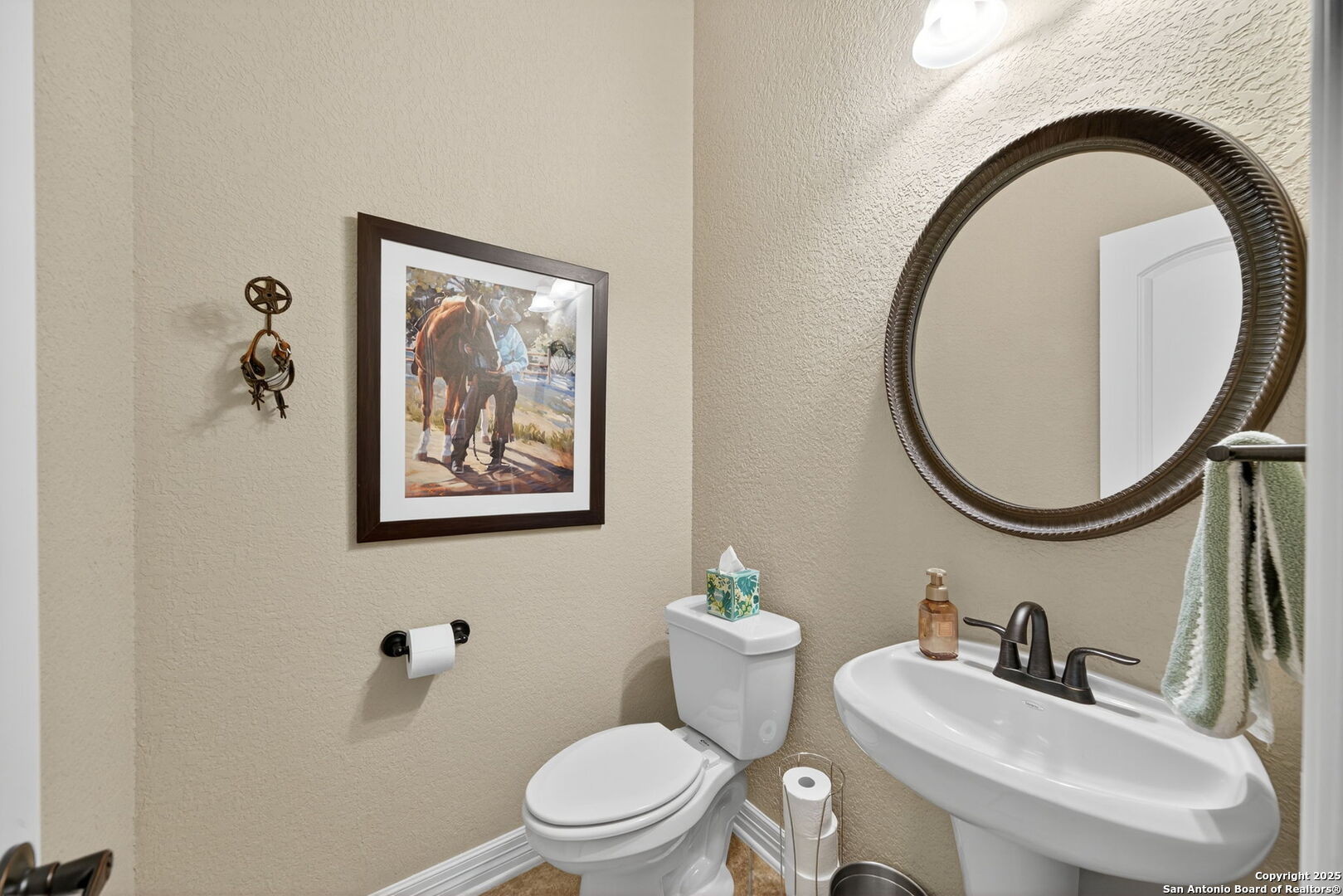 30210 Setterfeld Circle Fair Oaks Ranch, TX 78015 - Photo 23 of 30 a bathroom with a toilet a sink and a mirror
