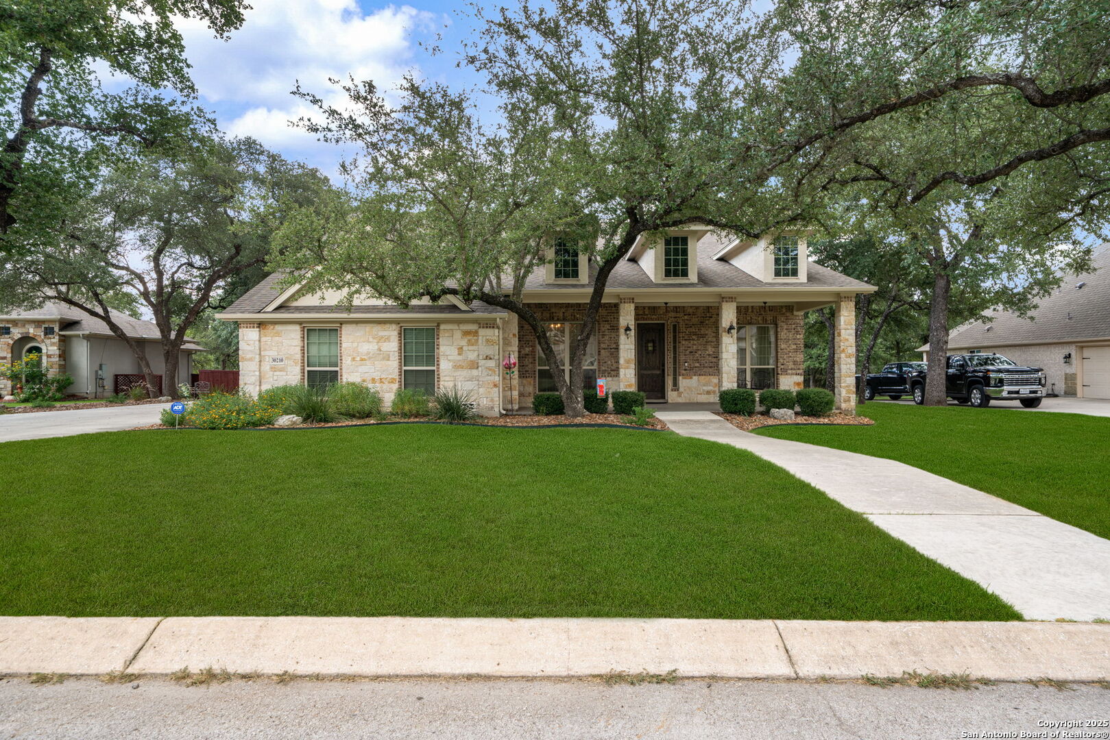30210 Setterfeld Circle Fair Oaks Ranch, TX 78015 - Photo 30 of 30 a front view of a house with a yard