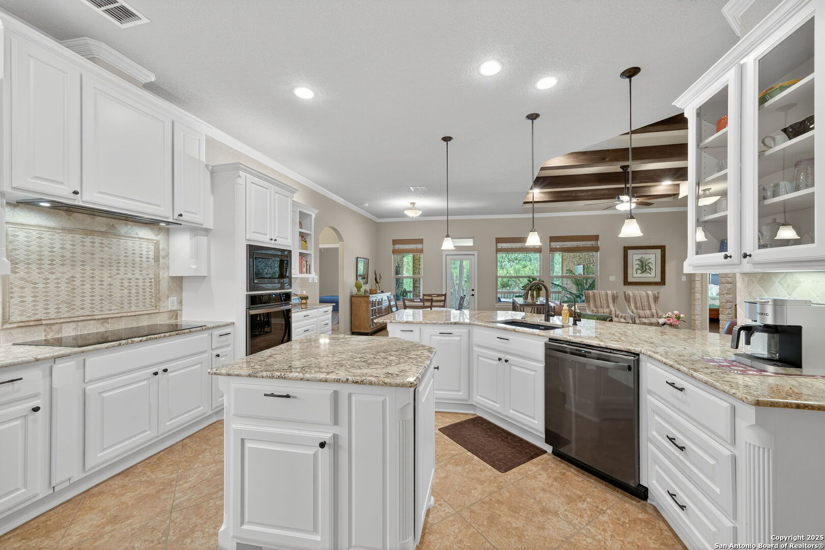 30210 Setterfeld Circle Fair Oaks Ranch, TX 78015 - Photo 5 of 30 a kitchen with granite countertop a sink stainless steel appliances and white cabinets