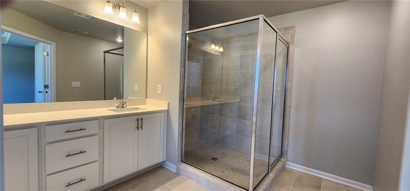 1476 Fern Ridge Lane Norcross, GA 30093 - Photo 12 of 19 a bathroom with a shower sink and mirror