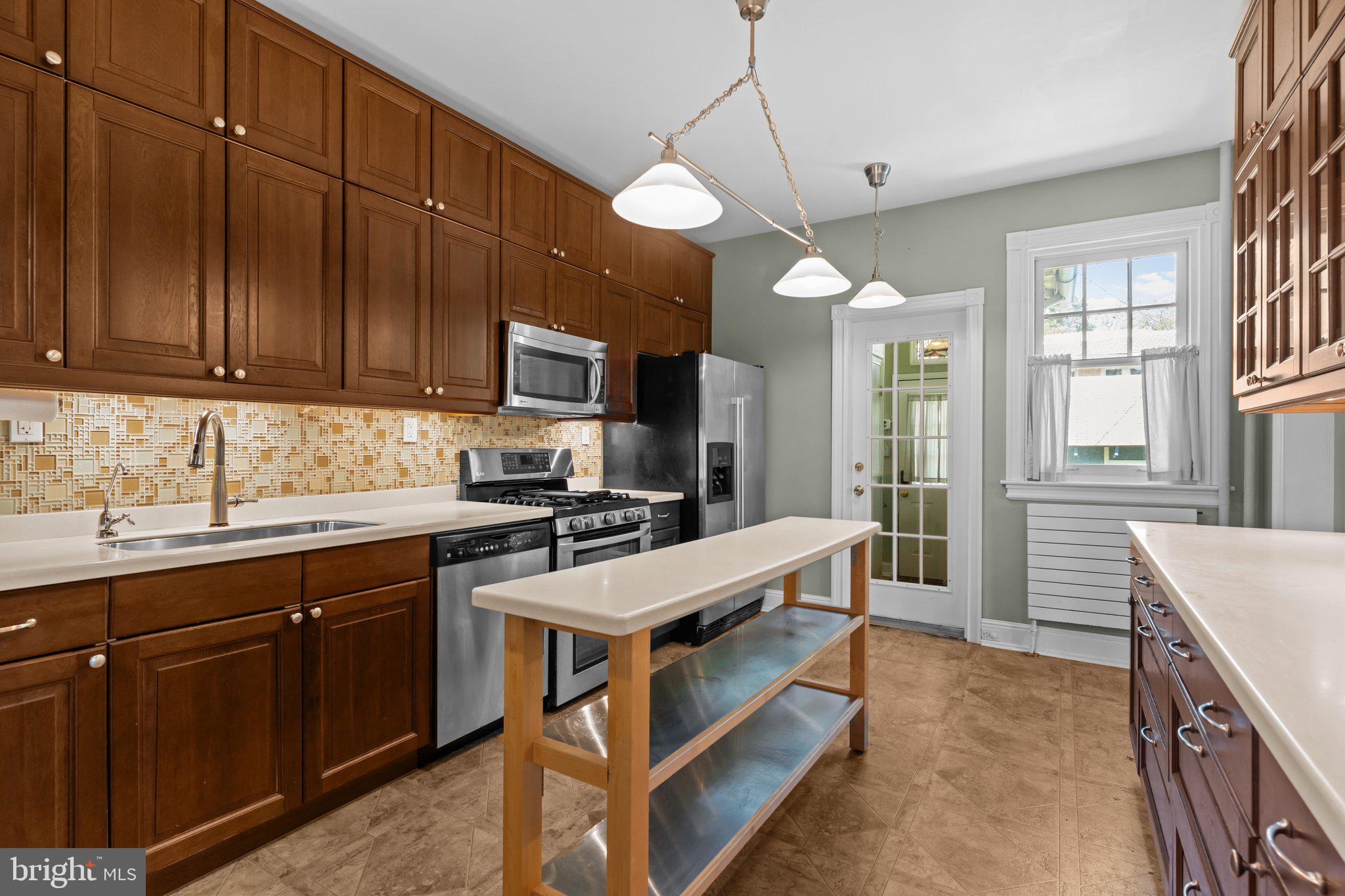 101 Cliff Terrace Wyncote, PA 19095 - Photo 6 of 21 a kitchen with a stove a sink a refrigerator and cabinets