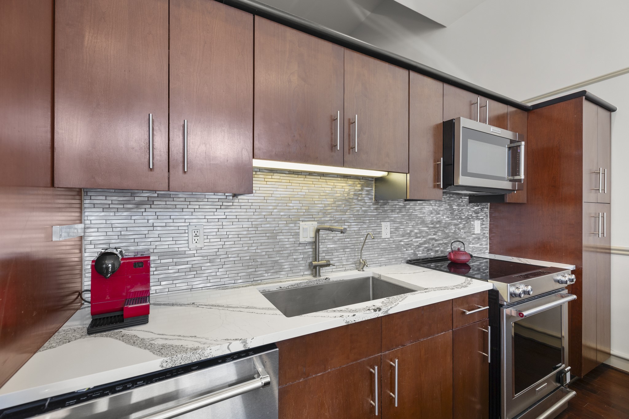 3311 Yupon Street, Unit 317 Houston, TX 77006 - Photo 13 of 28 a kitchen with a sink cabinets and stainless steel appliances