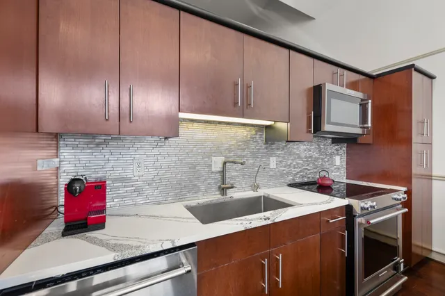 a kitchen with a sink cabinets and stainless steel appliances