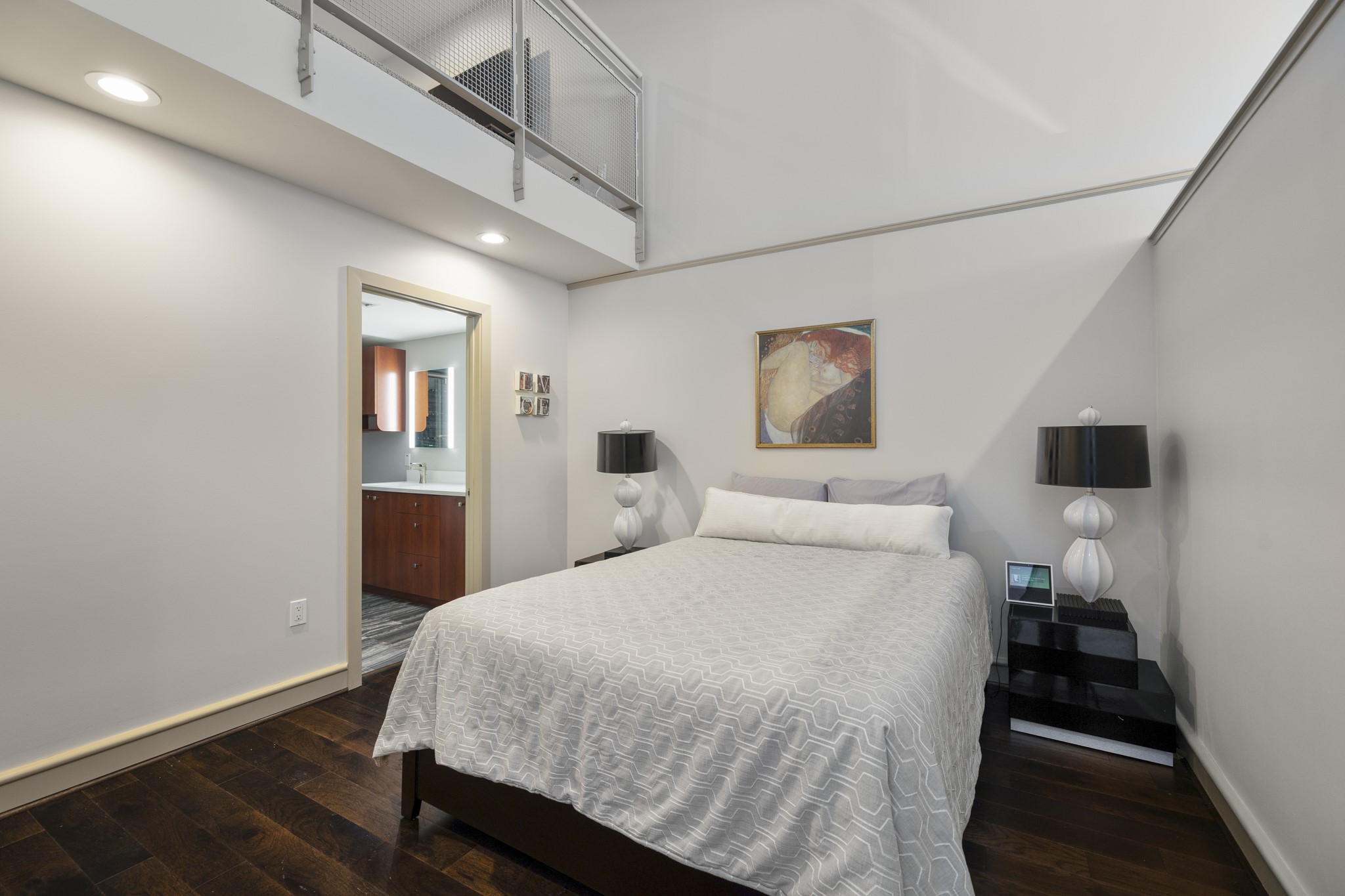 3311 Yupon Street, Unit 317 Houston, TX 77006 - Photo 16 of 28 a bedroom with a bed and a lamp on table
