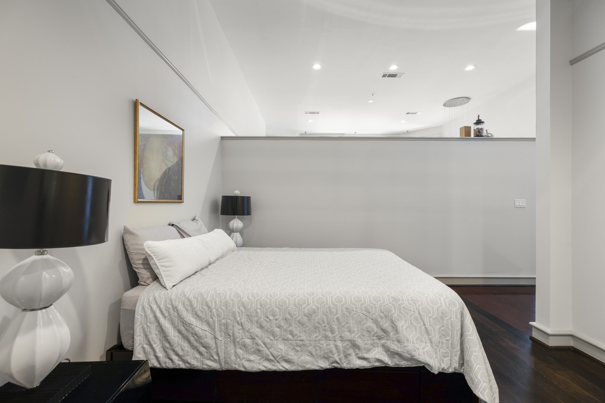 3311 Yupon Street, Unit 317 Houston, TX 77006 - Photo 18 of 29 a bedroom with a bed and wooden floor