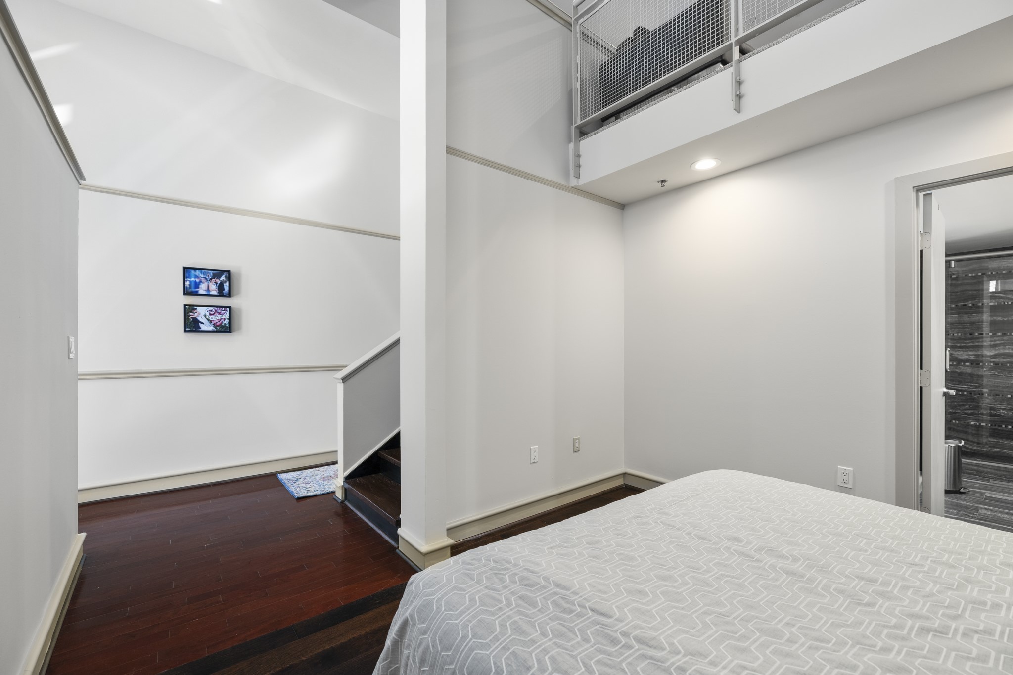 3311 Yupon Street, Unit 317 Houston, TX 77006 - Photo 19 of 29 a bedroom with a bed and a ceiling fan