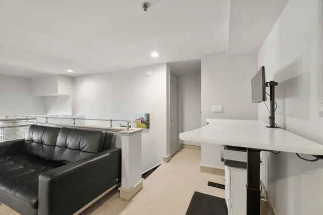 a kitchen with stainless steel appliances kitchen island a table and chairs in it