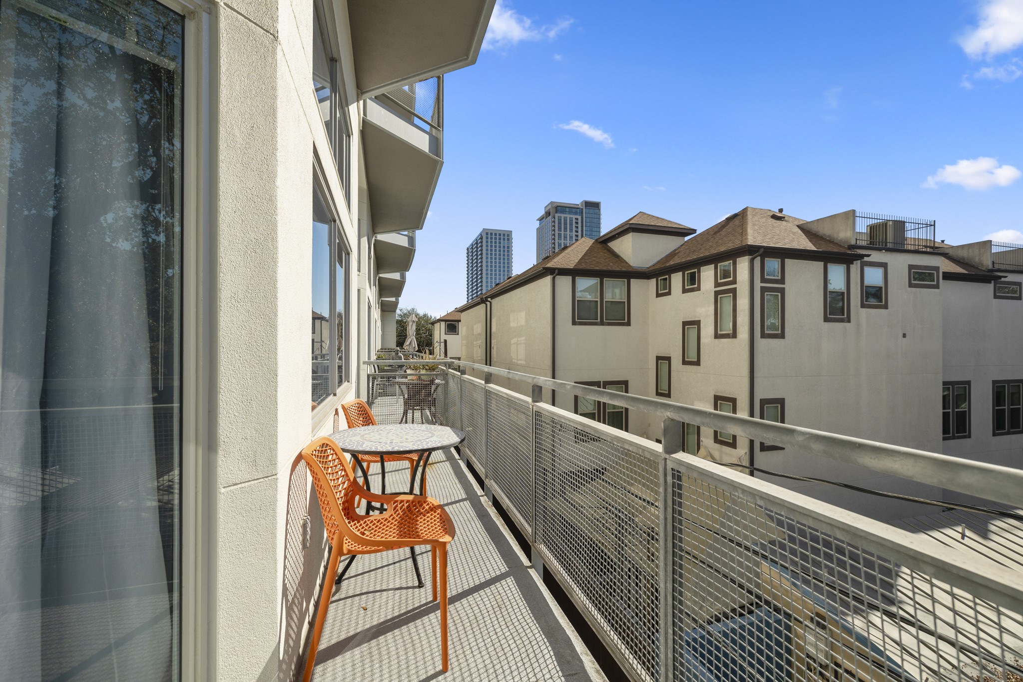 3311 Yupon Street, Unit 317 Houston, TX 77006 - Photo 10 of 29 a balcony with table and chairs with wooden floor