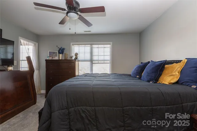 a bedroom with a bed and dresser with mirror