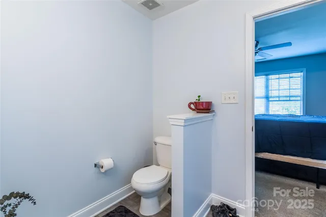 a bathroom with a toilet and a shower
