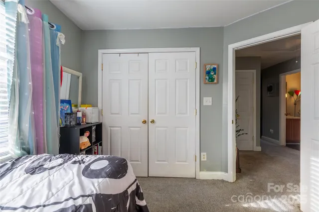 a bedroom with a bed and a mirror