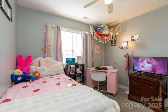 a bedroom with a bed dresser and window